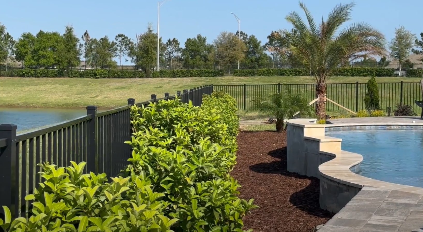 Complete landscape design featuring pool area, lawn maintenance, and professional hardscaping Modern backyard with swimming pool, professional landscaping, and well-maintained lawn in Citrus Heights